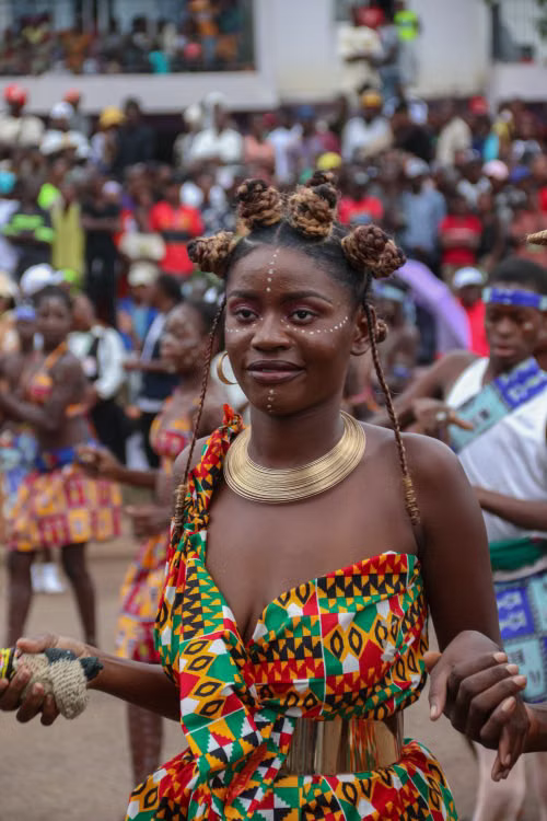 A woman dancing in kente dress